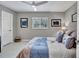 Cozy bedroom featuring neutral walls, a bright window, ceiling fan and comfortable bedding at 1761 Okolona St, North Port, FL 34287