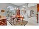 Bright dining area with arched windows, wood furniture, and open flow to other living spaces at 1761 Okolona St, North Port, FL 34287