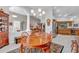 Open-concept dining area showcasing a wood table, seating, decorative elements, and seamless transition to the kitchen at 1761 Okolona St, North Port, FL 34287