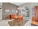 Elegant dining room boasts large arched windows, a wooden table with seating for four, and decorative accents at 1761 Okolona St, North Port, FL 34287