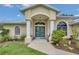 Inviting front entrance with a double door, decorative columns, and well-maintained landscaping at 1761 Okolona St, North Port, FL 34287