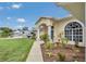 Charming home with arched entryway, lush landscaping, and a tranquil setting at 1761 Okolona St, North Port, FL 34287