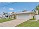 Beautiful home with a pristine lawn, spacious driveway, and a covered entry that welcomes guests at 1761 Okolona St, North Port, FL 34287