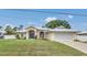 Beautiful single-story home with a well-manicured lawn, charming curb appeal, and a two-car garage at 1761 Okolona St, North Port, FL 34287