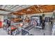 Spacious garage with wooden ceiling, cement walls, classic car, and table saw for working on projects at 1761 Okolona St, North Port, FL 34287