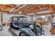 Spacious garage with wooden ceiling, cement walls, classic car, with lots of natural light at 1761 Okolona St, North Port, FL 34287