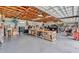 Spacious garage with wooden ceiling, cement walls, and large workbench with lots of storage and natural light at 1761 Okolona St, North Port, FL 34287
