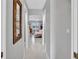 Hallway with access to the main bedroom, featuring neutral colors and bright lighting at 1761 Okolona St, North Port, FL 34287