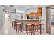 Well-lit kitchen with an eat-in bar, wood cabinets, stainless steel appliances and an open layout at 1761 Okolona St, North Port, FL 34287