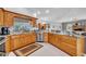 Kitchen area showcasing granite countertops, stainless steel appliances, and wood cabinetry at 1761 Okolona St, North Port, FL 34287