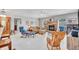 Bright living room with a fireplace, ceiling fan, comfortable seating, and tile flooring at 1761 Okolona St, North Port, FL 34287