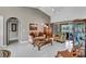 Cozy living room features neutral tones, vaulted ceilings, sliding glass doors and tile flooring at 1761 Okolona St, North Port, FL 34287