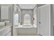 Bright bathroom with a soaking tub, shower, white cabinets, and neutral colors at 1761 Okolona St, North Port, FL 34287