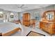 Spacious main bedroom suite with ceiling fan, wood furniture, and natural light at 1761 Okolona St, North Port, FL 34287