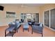 Inviting outdoor patio featuring wicker furniture and a ceiling fan, perfect for entertaining at 1761 Okolona St, North Port, FL 34287