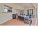 Covered patio with comfortable wicker furniture, perfect for outdoor relaxation and entertainment at 1761 Okolona St, North Port, FL 34287