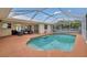 Beautiful outdoor pool with a screened-in enclosure and comfortable patio furniture at 1761 Okolona St, North Port, FL 34287