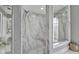 Modern bathroom with a marble tile shower and glass door, and neutral colors at 1761 Okolona St, North Port, FL 34287