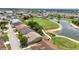 Scenic aerial view of homes bordering a golf course with lush green fairways and a serene pond at 1876 Birmingham Blvd, Punta Gorda, FL 33980