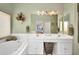 A well-appointed bathroom with double sinks, a garden tub, and white cabinetry adds elegance at 1876 Birmingham Blvd, Punta Gorda, FL 33980