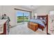 Bedroom features a sliding door leading to a backyard view of a pond and green space at 1876 Birmingham Blvd, Punta Gorda, FL 33980