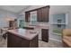 A well-lit kitchen with brown cabinets, an island, and modern appliances offers a functional space at 1876 Birmingham Blvd, Punta Gorda, FL 33980
