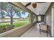 Covered patio with views of the lake, seating area, and ceiling fans at 1876 Birmingham Blvd, Punta Gorda, FL 33980