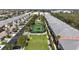 Community aerial view showcasing tennis court, green spaces, and rows of well-maintained homes in a desirable location at 2002 Bal Harbor Blvd # 1712, Punta Gorda, FL 33950