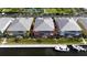 Aerial view of modern waterfront condos with docks, boats, and a tennis court at 2002 Bal Harbor Blvd # 1712, Punta Gorda, FL 33950