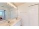 Bathroom with double vanity, large mirror, and a view of the bedroom at 2002 Bal Harbor Blvd # 1712, Punta Gorda, FL 33950