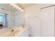 Bathroom with double vanity, large mirror, and a view of the bedroom at 2002 Bal Harbor Blvd # 1712, Punta Gorda, FL 33950