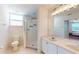 Bright bathroom with a white vanity, dual sinks, and a glass enclosed walk-in shower at 2002 Bal Harbor Blvd # 1712, Punta Gorda, FL 33950