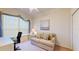 Cozy bedroom featuring a comfortable sofa, a desk, and soft natural light from the window at 2002 Bal Harbor Blvd # 1712, Punta Gorda, FL 33950