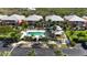 Community pool with sun loungers, palm trees, and a cabana, perfect for relaxation and socializing at 2002 Bal Harbor Blvd # 1712, Punta Gorda, FL 33950