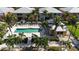 Community pool with sun loungers, palm trees, and a cabana, perfect for relaxation and socializing at 2002 Bal Harbor Blvd # 1712, Punta Gorda, FL 33950