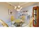 Dining room featuring an elegant chandelier, glass table, and ornate chairs, with a view into the kitchen at 2002 Bal Harbor Blvd # 1712, Punta Gorda, FL 33950