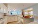 Open kitchen with modern appliances, white cabinetry, and views of the living and dining areas at 2002 Bal Harbor Blvd # 1712, Punta Gorda, FL 33950
