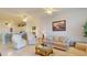 Well-lit living room with an open layout to the kitchen, tiled floors, and comfortable seating arrangement at 2002 Bal Harbor Blvd # 1712, Punta Gorda, FL 33950