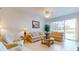 Bright and airy living room features tile flooring, comfortable seating, and expansive windows with water views at 2002 Bal Harbor Blvd # 1712, Punta Gorda, FL 33950