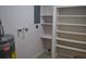 Basement area featuring a water heater and additional storage shelves at 21275 Austin Ave, Port Charlotte, FL 33952