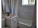 Bathroom featuring a vanity sink, bathtub with marble tile backsplash, and window at 21275 Austin Ave, Port Charlotte, FL 33952