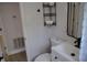 Cozy bathroom featuring a modern sink, toilet, and overhead storage at 21275 Austin Ave, Port Charlotte, FL 33952