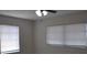 Bedroom with two windows offering natural light and a ceiling fan at 21275 Austin Ave, Port Charlotte, FL 33952