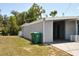 Side view of the house featuring a carport with parking and storage at 21275 Austin Ave, Port Charlotte, FL 33952