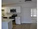Updated kitchen with white cabinets, stainless steel appliances, and marble backsplash at 21275 Austin Ave, Port Charlotte, FL 33952