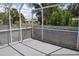 Enclosed porch area overlooking a yard and lush foliage with decorative railings at 21275 Austin Ave, Port Charlotte, FL 33952