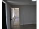 View into a light and neutral room through a doorway, featuring wood floors at 21275 Austin Ave, Port Charlotte, FL 33952