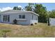 View of the side of the home, showcasing the yard and fencing at 21275 Austin Ave, Port Charlotte, FL 33952