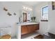 Bathroom featuring a double sink vanity with wood accents and tile flooring at 22349 Columbus Ave, Port Charlotte, FL 33954