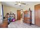 Charming bedroom with wood-look flooring, ceiling fan, and an antique wood armoire at 22349 Columbus Ave, Port Charlotte, FL 33954